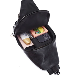 Detail showing high-capacity interior of the black PU crossbody bag with daily essentials