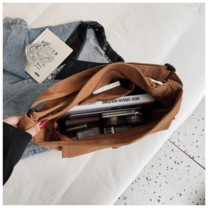 Interior view of brown canvas tote bag showing large capacity for books and essentials