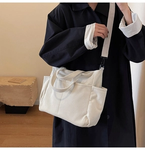 Detail shot of the corduroy crossbody bag showing white ribbed texture and pocket design
