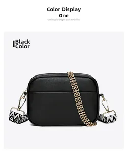 Detail of black camera bag showing lychee grain leather and geometric woven strap