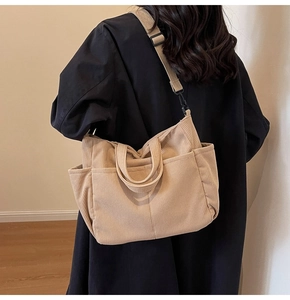 Detail view of khaki corduroy tote bag showing textured stripes and adjustable strap