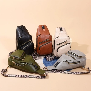 Flat lay of colorful PU crossbody bags with unique geometric patterned shoulder straps