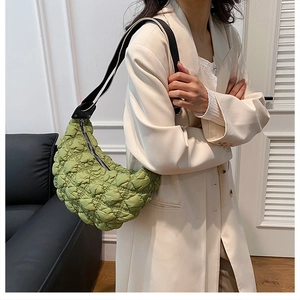 Dettaglio della borsa a mezzaluna in nylon trapuntato verde con tracolla regolabile