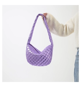 Detail of purple metallic quilted moon bag with glossy finish and rhombus pattern