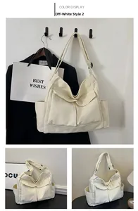 Detail of off-white canvas shoulder bag featuring large front flap pockets and strap buckle