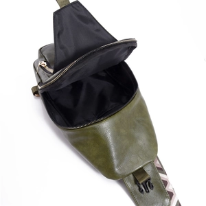 Detail view of dark green PU leather crossbody bag showing inner lining and zipper closure