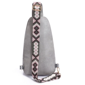 Detail of light gray PU leather crossbody bag with wide geometric pattern woven strap