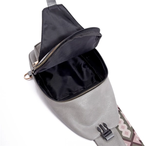 Detail view of the interior black fabric lining and durable zipper of the grey PU crossbody bag