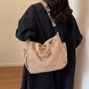 Minimalist beige corduroy crossbody bag with adjustable straps and multiple pockets