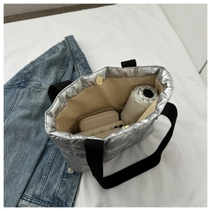 Silver quilted tote bag showing spacious interior capacity with magnetic closure
