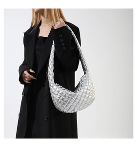 Silver metallic quilted hobo bag styled with a black blazer on a fashion model