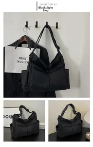 Detail view of black canvas crossbody bag with multiple storage pockets and utility design
