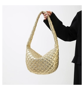 Close-up of gold quilted hobo bag featuring metallic finish and diamond stitch pattern