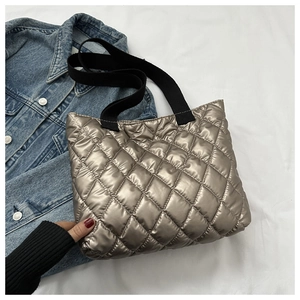 Quilted metallic tote bag in champagne gold with diamond stitching and black wide straps