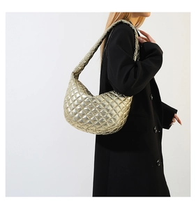 Detail of metallic gold quilted Hobo shoulder bag with elegant diamond pattern
