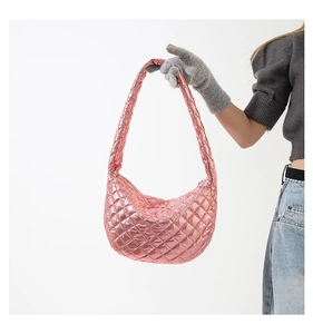 Detailed view of the metallic pink quilted texture on this large crescent shoulder bag