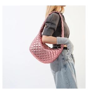 Detail of metallic pink quilted hobo bag featuring premium stitching and glossy finish