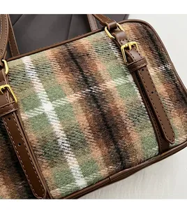 Detail of vintage wool plaid fabric texture and premium leather strap with gold buckle