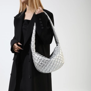 Silver metallic quilted hobo bag with large lattice pattern shown on fashion model