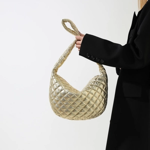 Elegant gold metallic quilted clutch bag with half-moon shape and shoulder strap