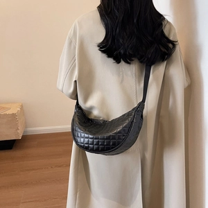 Minimalist black quilted faux leather crossbody bag with chic crescent moon silhouette