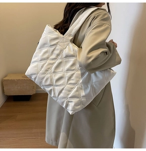 Close-up of quilted tote bag with large capacity and soft padded fabric texture