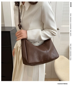Close-up of deep brown PU leather hobo bag with adjustable strap on a model shoulder
