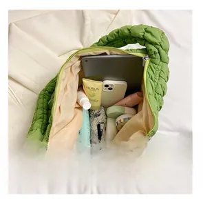 Macro shot of green puffy tote bag interior showing spacious capacity for daily essentials