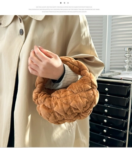 Detailed close-up of brown quilted plush handbag showing soft texture and stitching