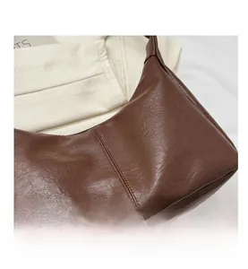 Detailed view of dark brown PU leather tote with premium pebble texture and neat stitching