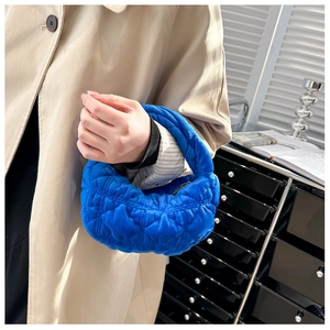 Detail of blue quilted cloud handbag showing the soft plush texture and trendy ruched design