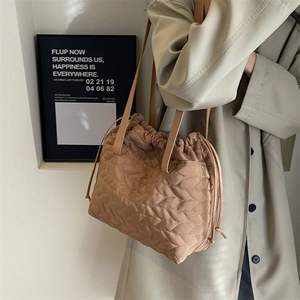 Khaki quilted drawstring tote bag in waterproof nylon with wavy stitching for women