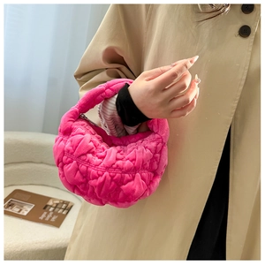 Macro view of bright pink plush hobo bag with luxury quilted faux fur and quilted texture