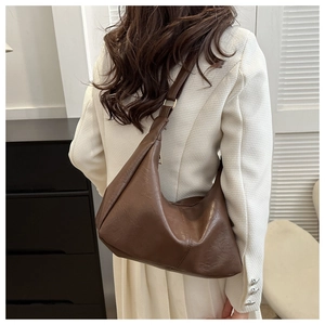 Detail view of the brown PU leather tote bag with metallic adjustable buckle on shoulder strap