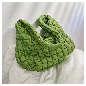 Detailed texture of bright green quilted puffy cloud tote bag with soft wide handle