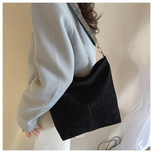 Minimalist black tote bag with retro ethnic embroidered wide strap and bronze hardware