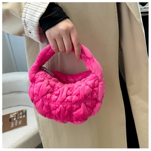 Close-up of rose pink plush cloud bag featuring diamond quilting and silver zipper