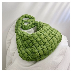 Detailed shot of grass green quilted cloud bag with textured pleated bubble fabric