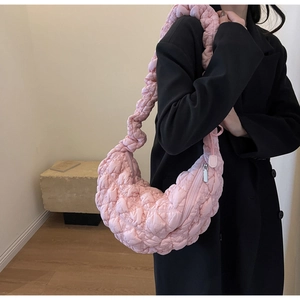 Pink quilted puffer crossbody bag with cloud texture and crescent shape for women
