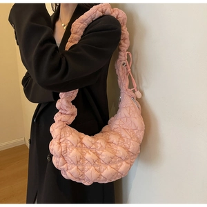 Detail of pink quilted bubble hobo bag with textured fabric and metallic zipper