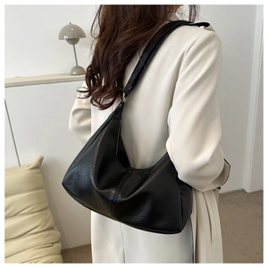Side view of black PU leather hobo bag with pebble texture and soft crescent shape