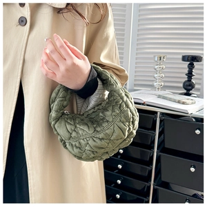 Detail view of olive green quilted cloud bag showing soft texture and geometric pattern