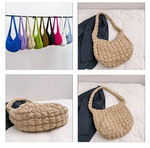 Macro detail of quilted cloud texture on casual large capacity nylon dumpling shoulder bag