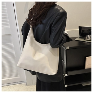 Minimalist cream white PU leather tote bag shown on model for daily office commute fashion