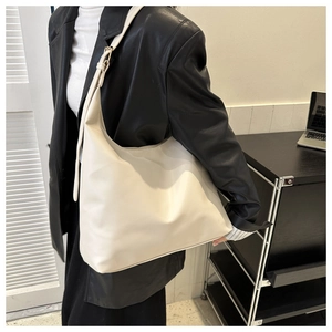 Detail view of large cream hobo bag with adjustable silver buckle for daily commute