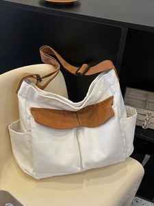 Versatile beige canvas tote bag with brown straps and large front pockets for daily use