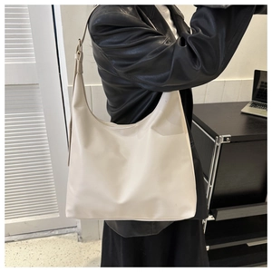 Side view of large cream hobo bag with adjustable wide shoulder strap for daily commute