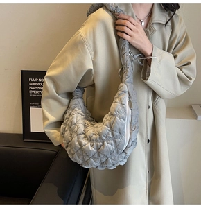 Detailed view of grey quilted velvet hobo bag with a soft texture and wide shoulder strap