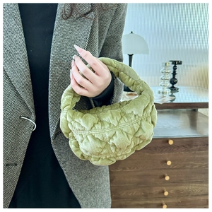 Detail view of light green cloud pleated bag with soft velvet texture and handle