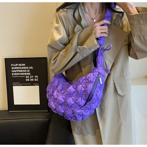 Detail of high-saturation purple quilted crescent bag showing the fluffy texture and ruffles